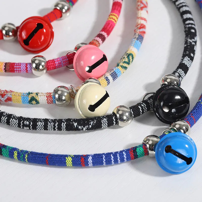 Ethnic pattern adjustable pet collar with bell attachment shown in multiple colour options
