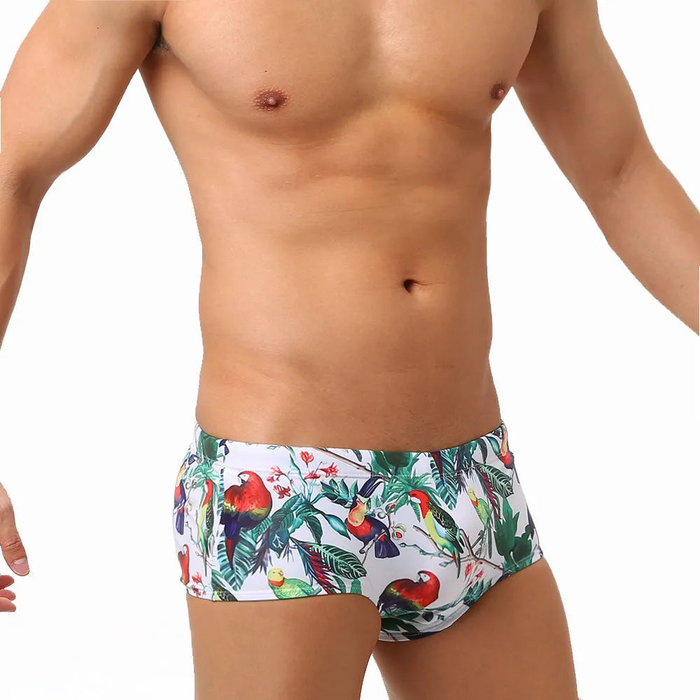 Men's floral bird print swim trunks with cup compartment in blue and white design