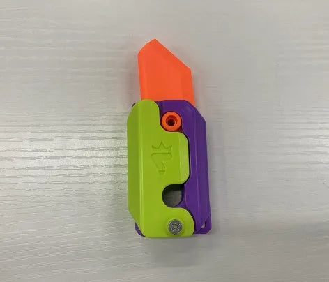 3D printed carrot gravity fidget knife in orange purple green colour, showing blade partly extended from sheath
