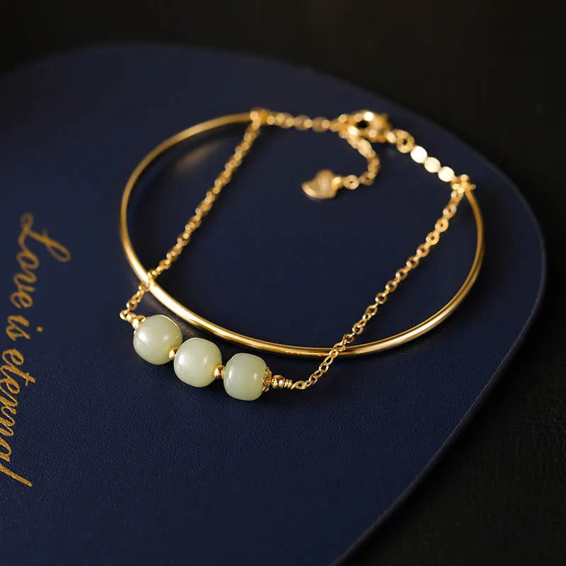 Women's jade bracelet with gold inlay detailing showing single bead version
