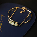 Women's jade bracelet with gold inlay detailing showing single bead version