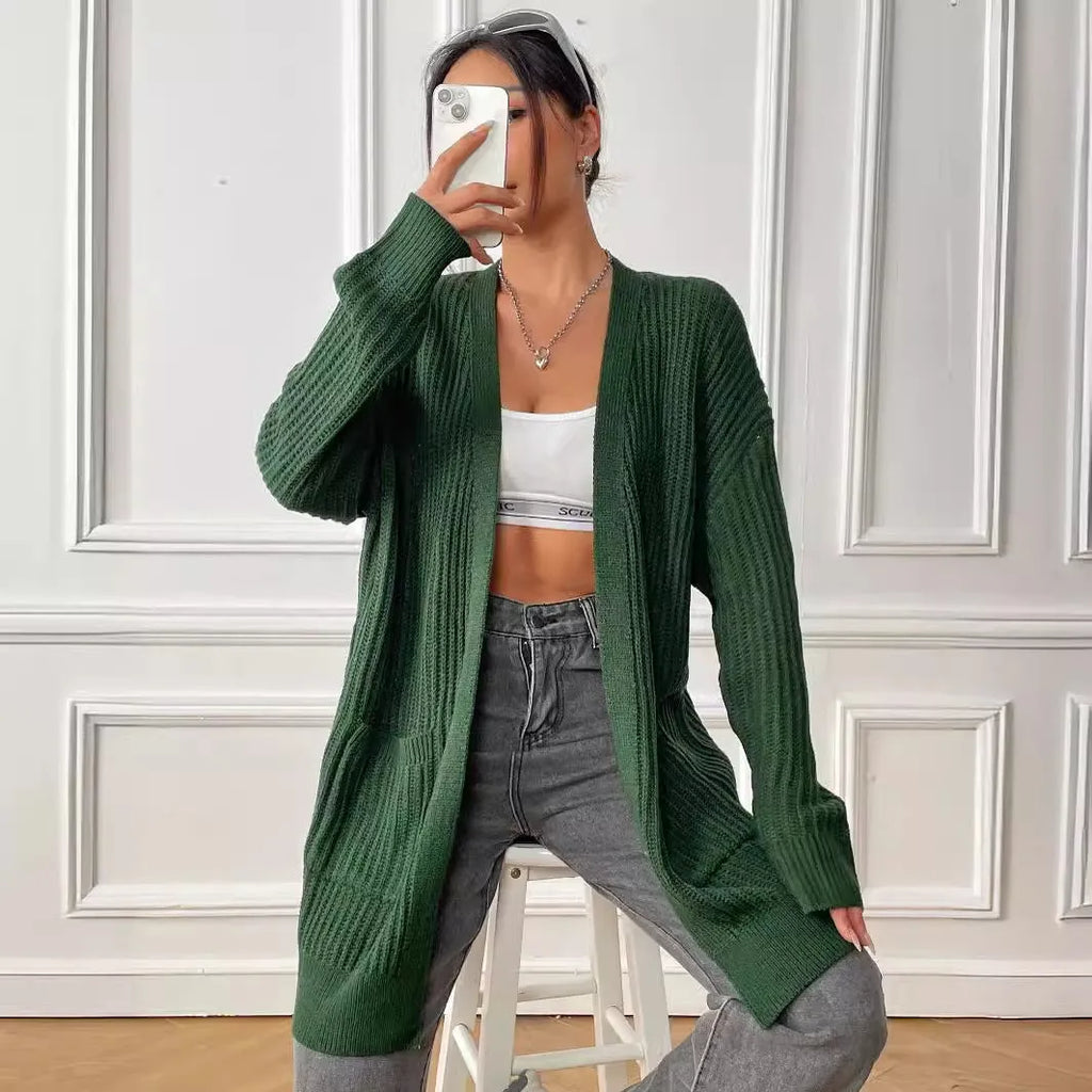 Women's dark green loose-fit acrylic cardigan sweater with double pockets and long sleeves.