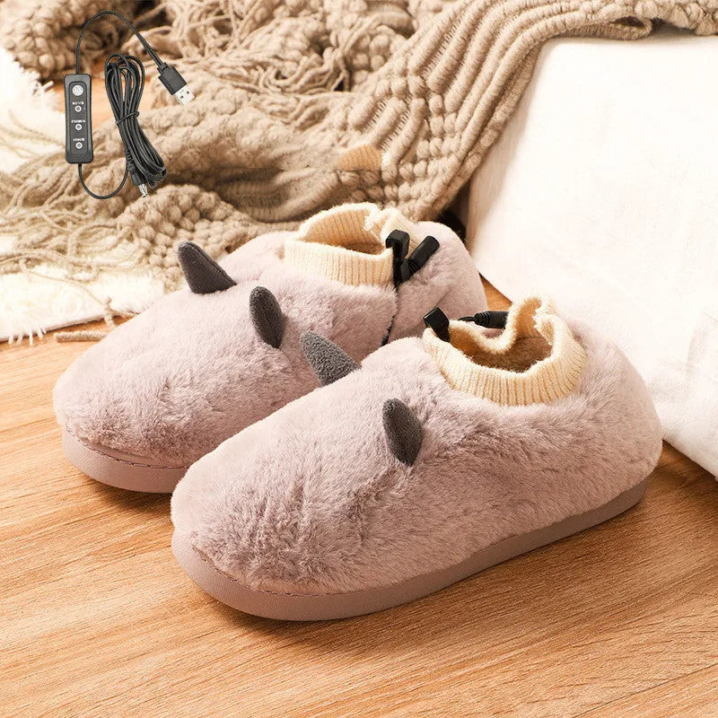 USB electric heated slippers in black with a soft velvet upper and a plastic sole.