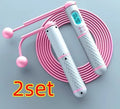 Intelligent counting skipping rope with black yellow ABS handles and load-bearing balls on a wooden floor