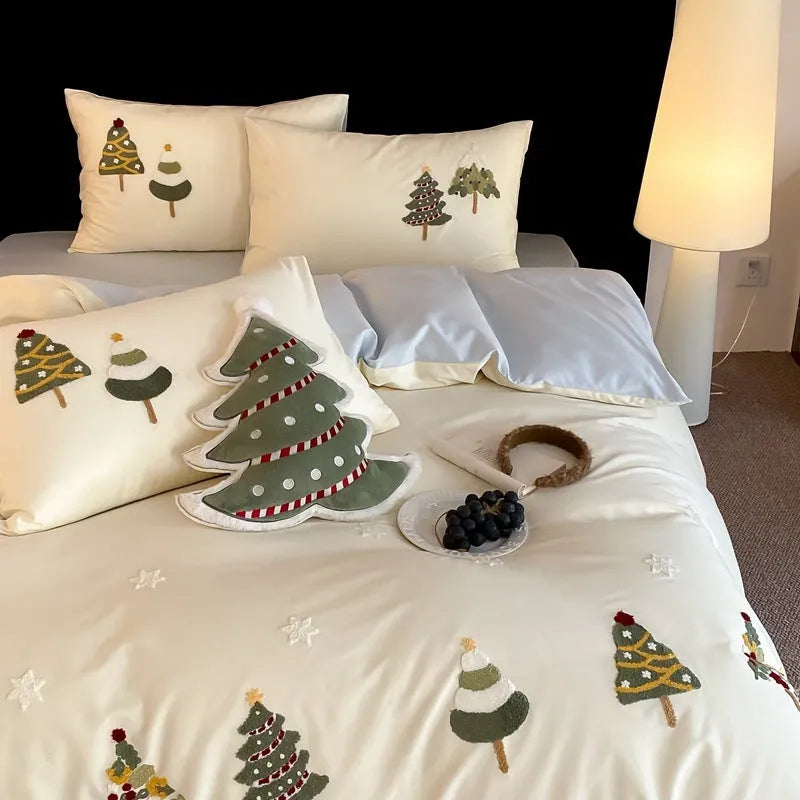 Cream blue cotton duvet cover and pillowcases with embroidered green Christmas tree and flower design.