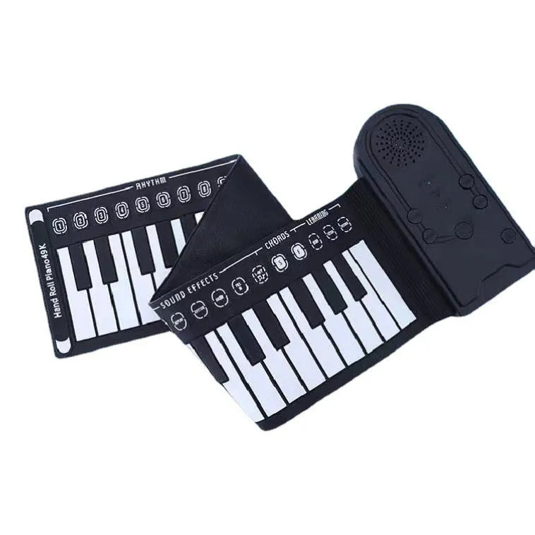 Compact folding electronic keyboard with 49 black silicone keys, shown in gloss black finish, rolled for storage next to its control panel.