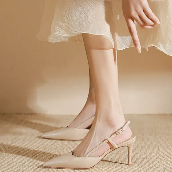 Apricot coloured women's high-heeled sandals with a single strap and buckle on a rubber sole.
