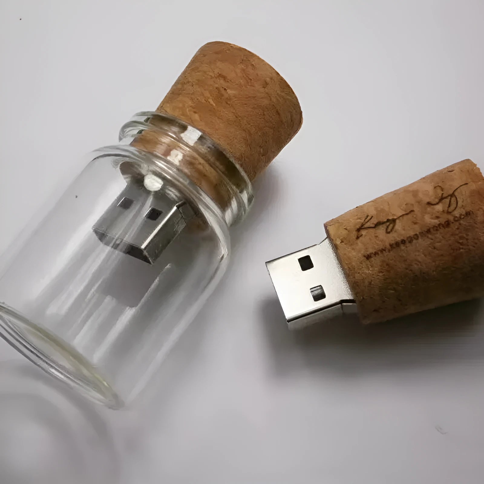 Transparent plastic bottle-shaped USB flash drive with a wooden ship model inside.