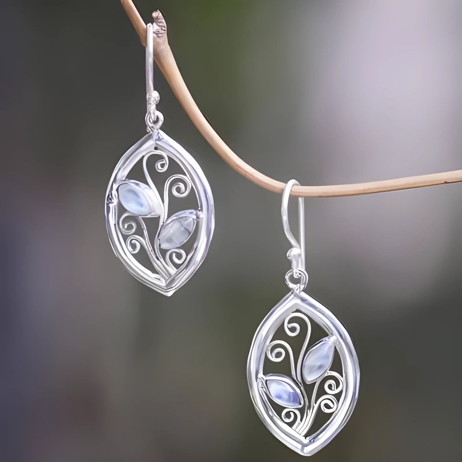 Silver colour leaf-shaped earrings with embedded colourful moonstones and European design elements
