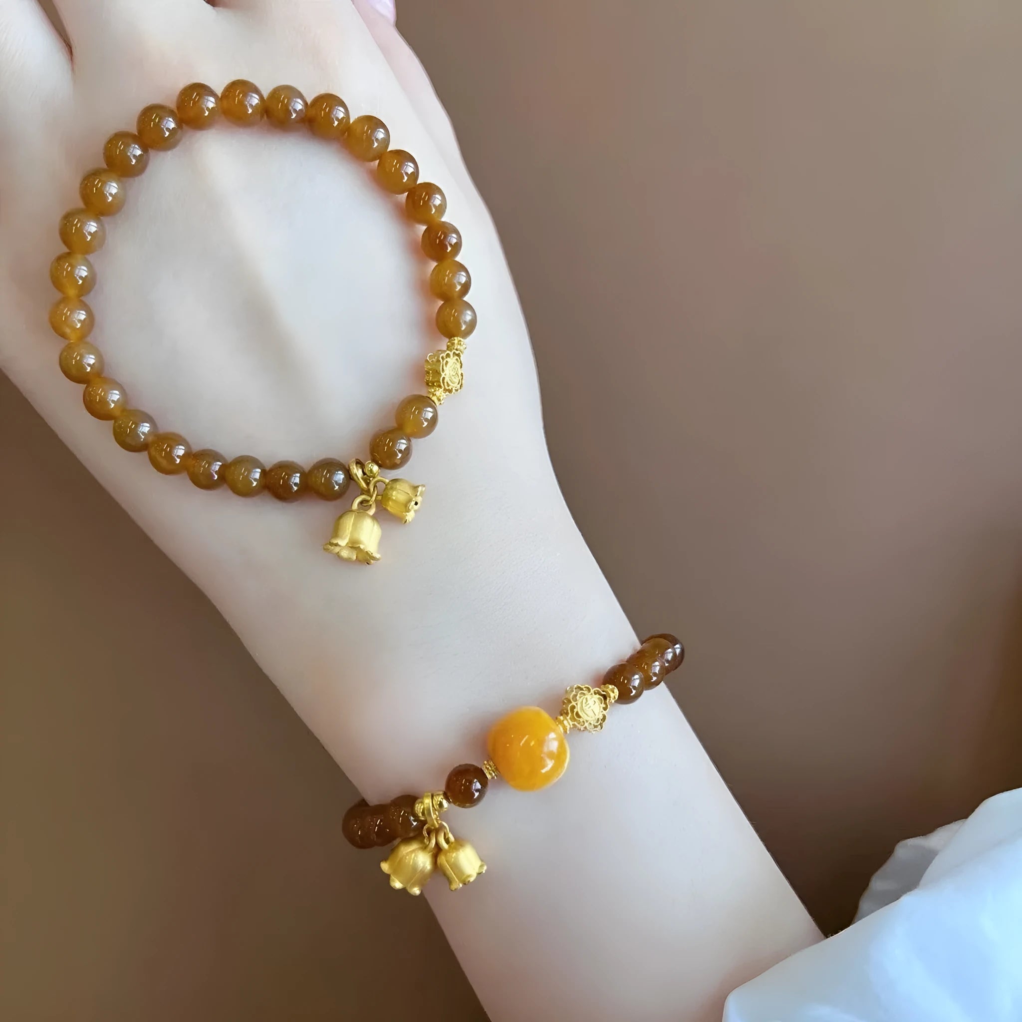 Women's natural stone Lily bracelet with electroplated finish and floral design in caramel beeswax colour