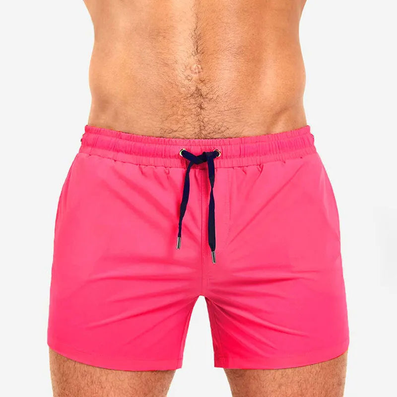 Polyester sports shorts with mesh lining in multiple colours including army green and rose red.