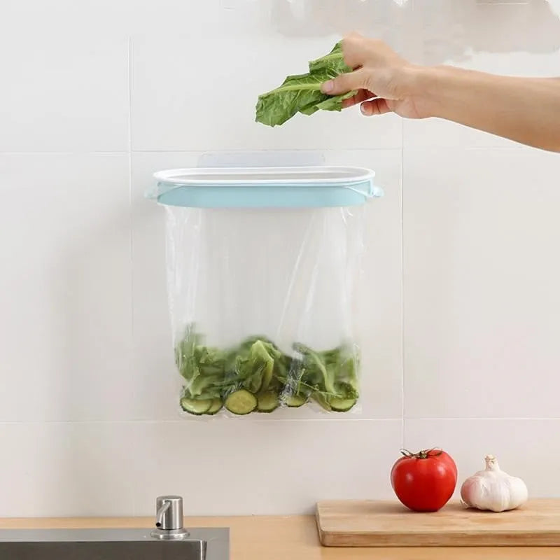 Blue plastic kitchen garbage bag storage rack mounted on a cabinet door.