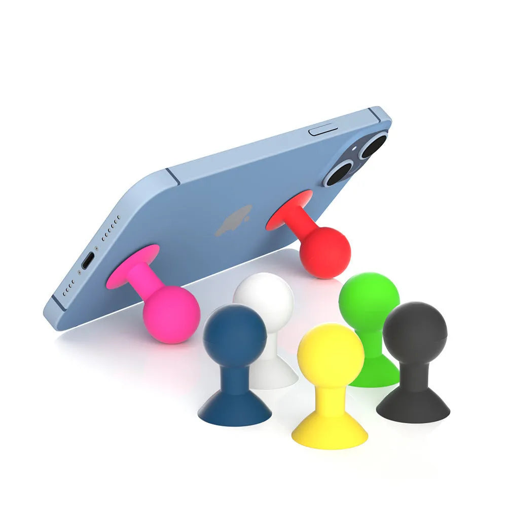 Silicone octopus ball mobile phone holder in blue holding a smartphone on a desk