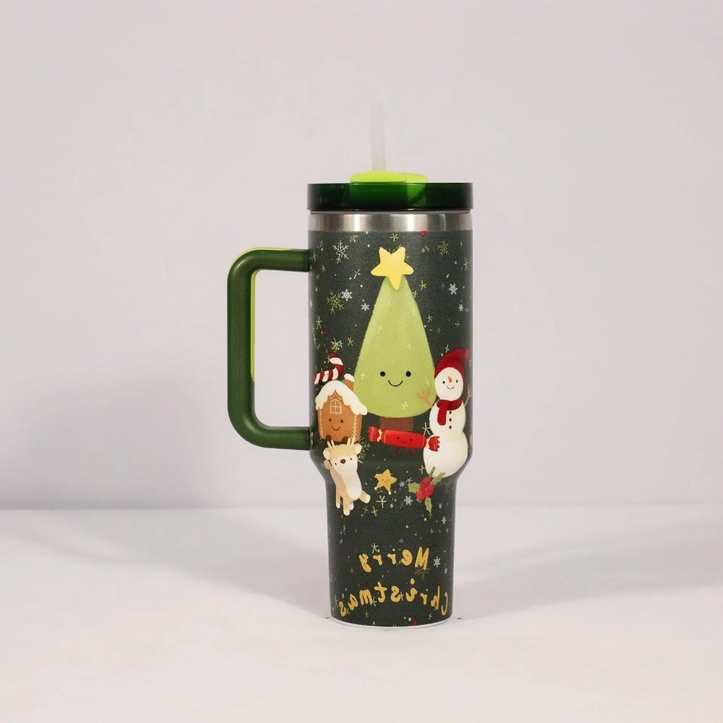Red Christmas pattern stainless steel travel tumbler with handle, straw, and lid on a table.