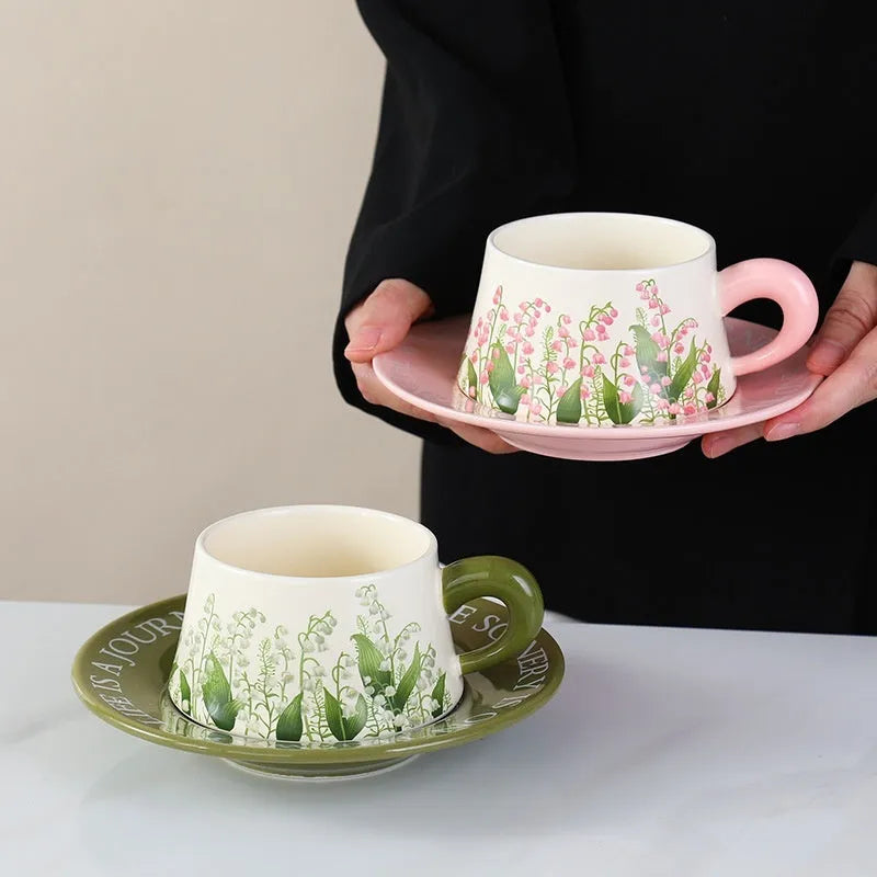 Ceramic coffee cup and saucer set with two mugs, plates, and spoons in couple designs