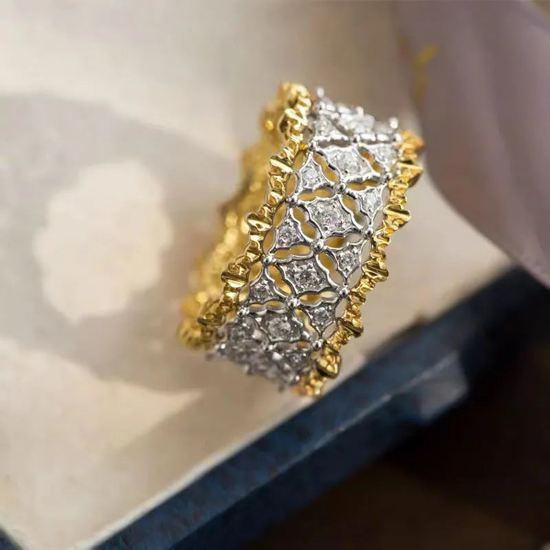 Geometric two-tone gold zircon ring with a round stone on a copper band.