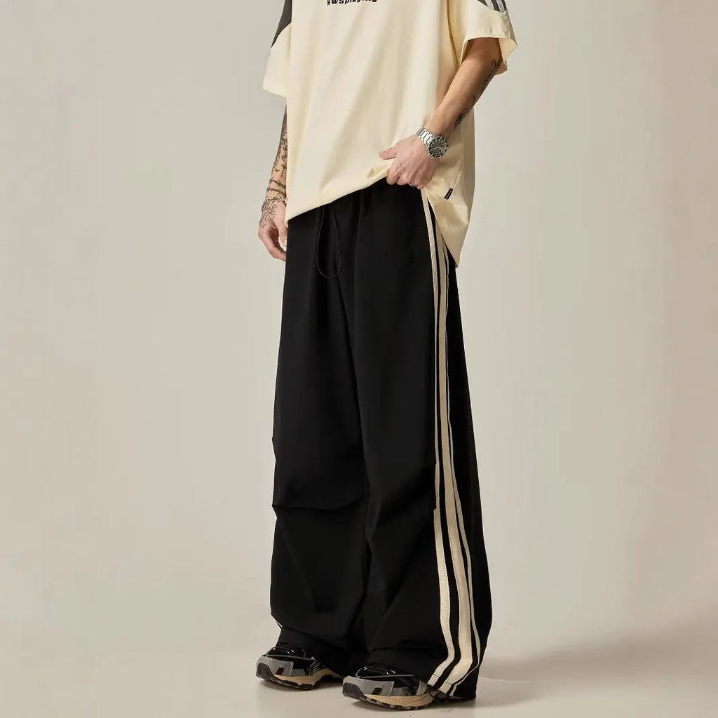Black wide leg climbing pants for men showing high waist and straight leg design