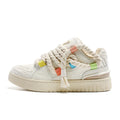 Creamy white retro skate shoes with old damage lace detailing and rubber soles