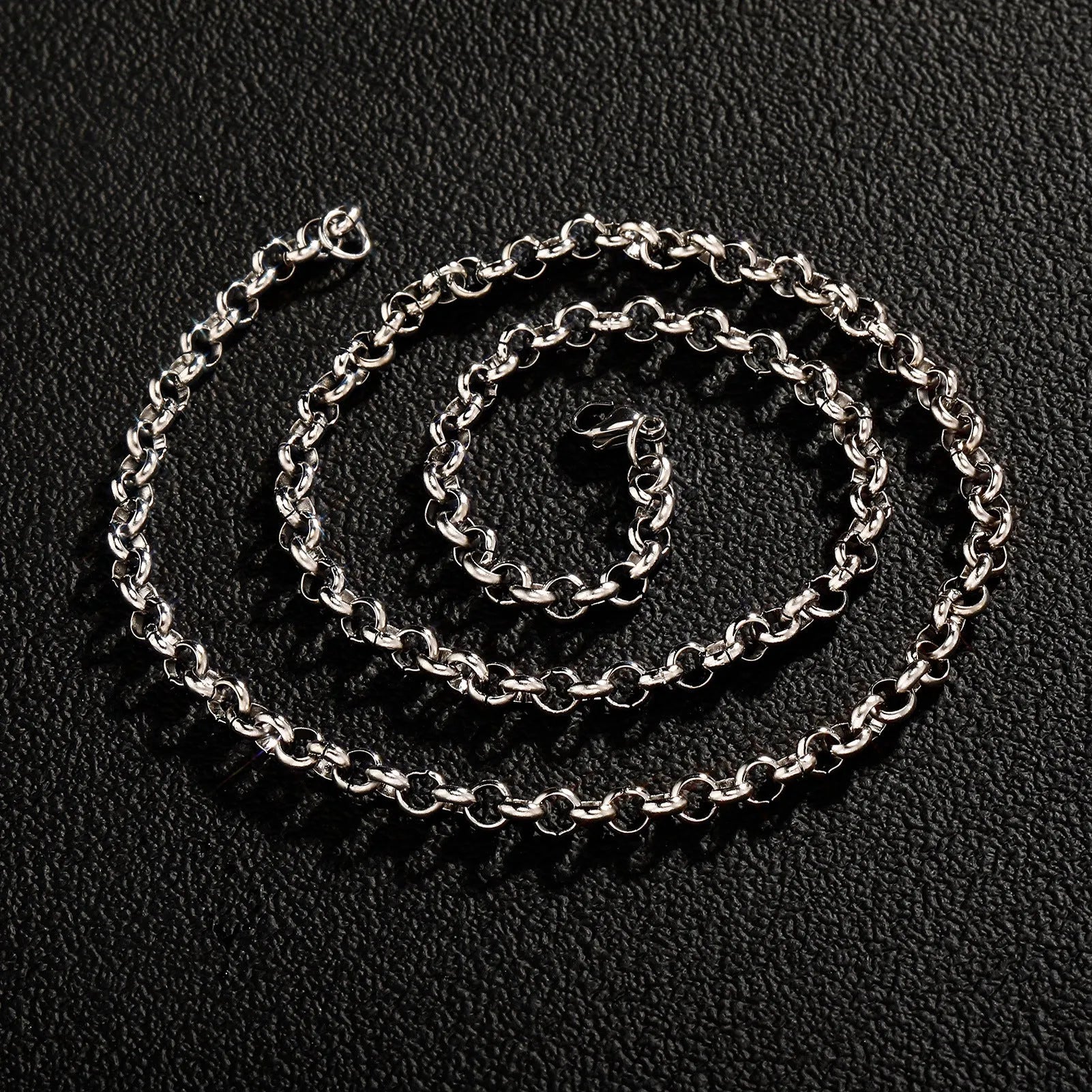 Silver stainless steel men's punk ring buckle necklace with O-ring chain on a neutral background