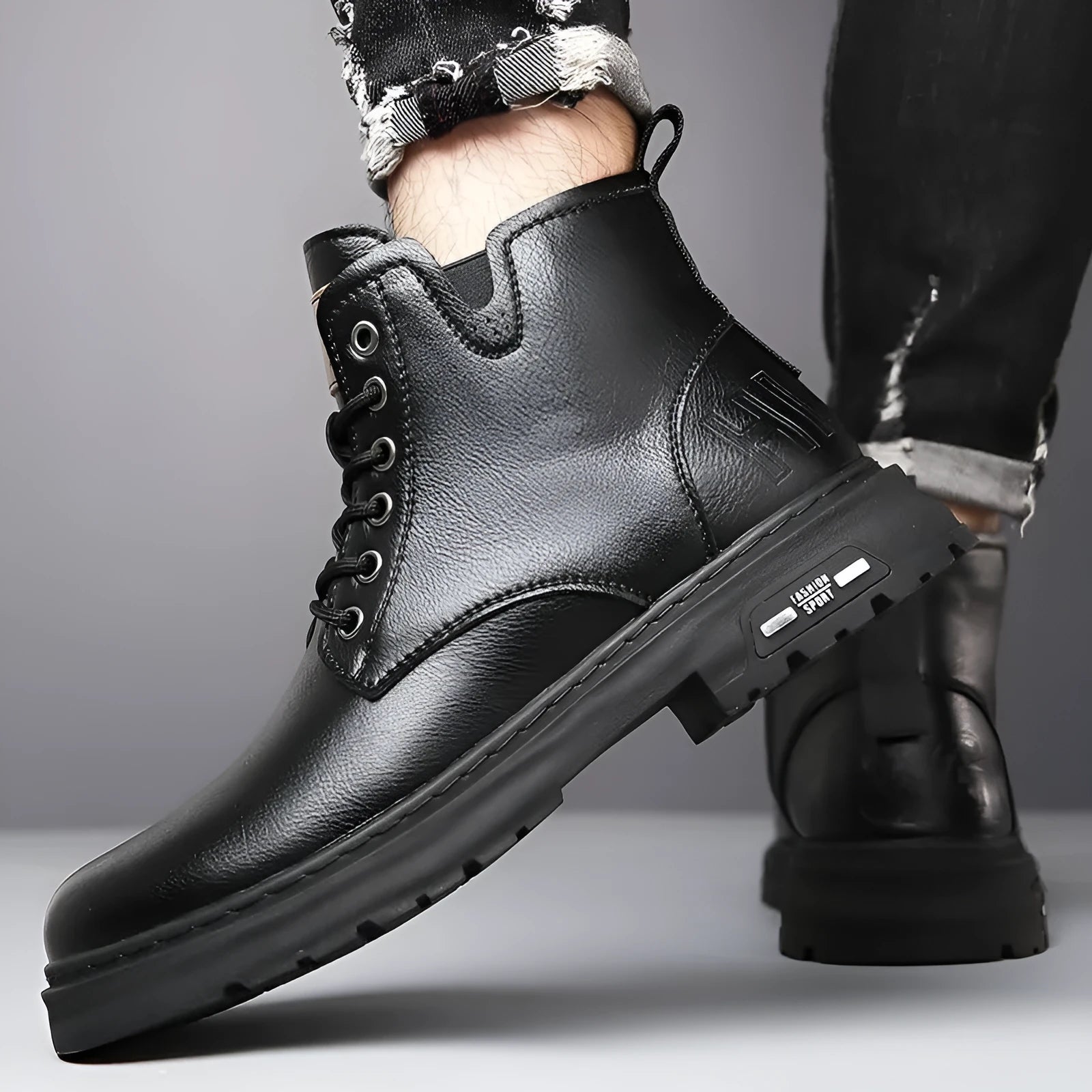 Men's black lace-up Martin boot with thick rubber sole and round toe on a neutral background.