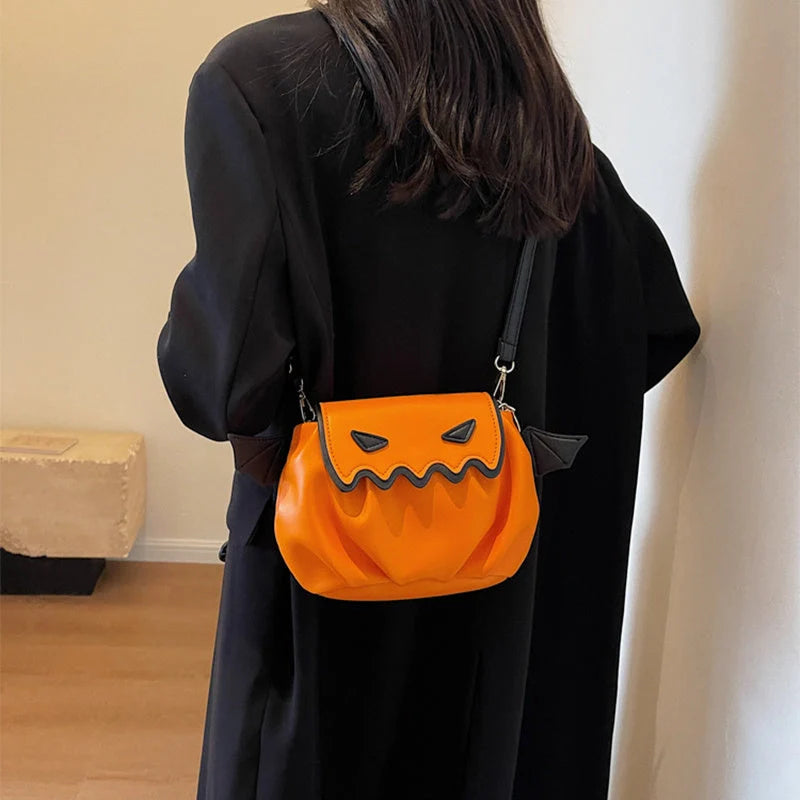 Halloween pumpkin cartoon crossbody bag with wings in black, white, and orange