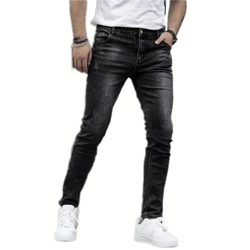 Men's black stretch jeans with straight leg and skinny opening, laid flat.