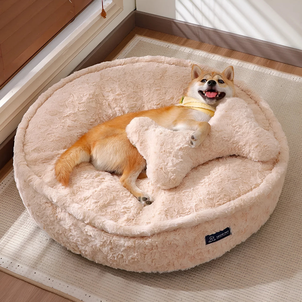 Milk tea colour round pet bed with a removable cloth cover on a wooden floor.