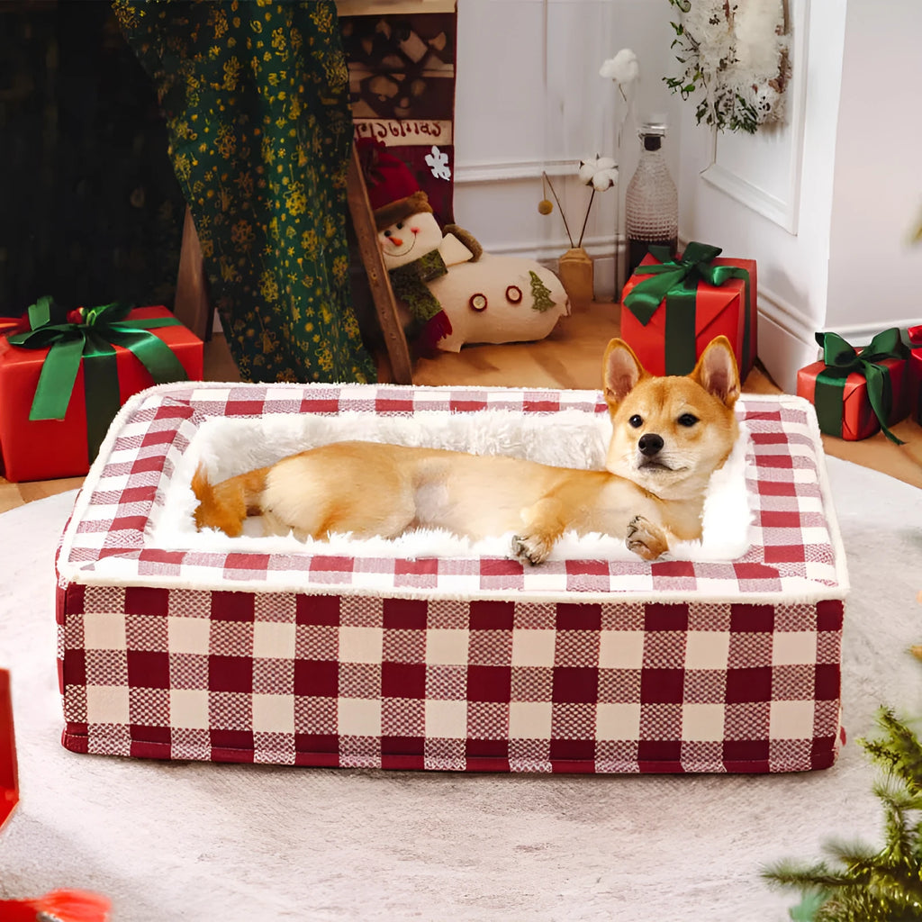 Classic plaid pattern dog cushion with removable cover in red, shown next to a black crate.