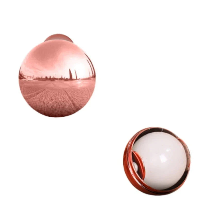 Reusable Pet Hair Remover Ball in Liquid Silver and Rose Gold colors, featuring hydro-slips technology and diatom mud for effective cleaning of clothes, furniture, and surfaces.