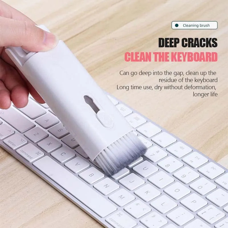 Multifunctional electronics cleaning kit with cleaning pen, brush, key puller, and spray bottle on a white background