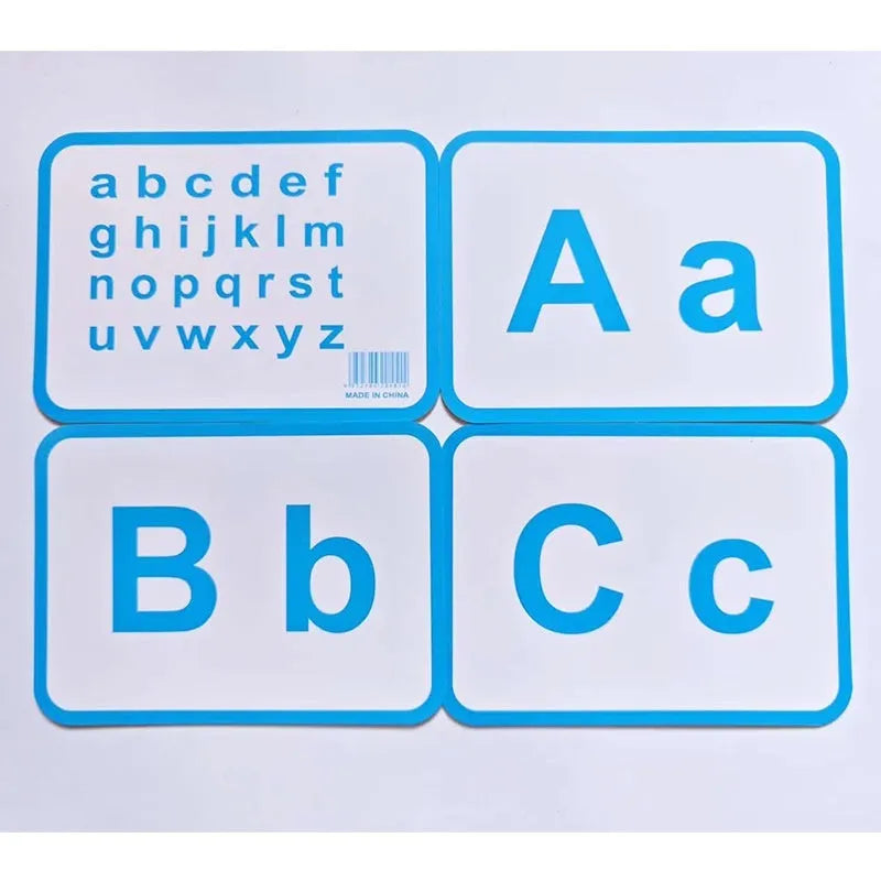 28 paper children's recognition literacy cards covering English and number learning laid out on a flat surface