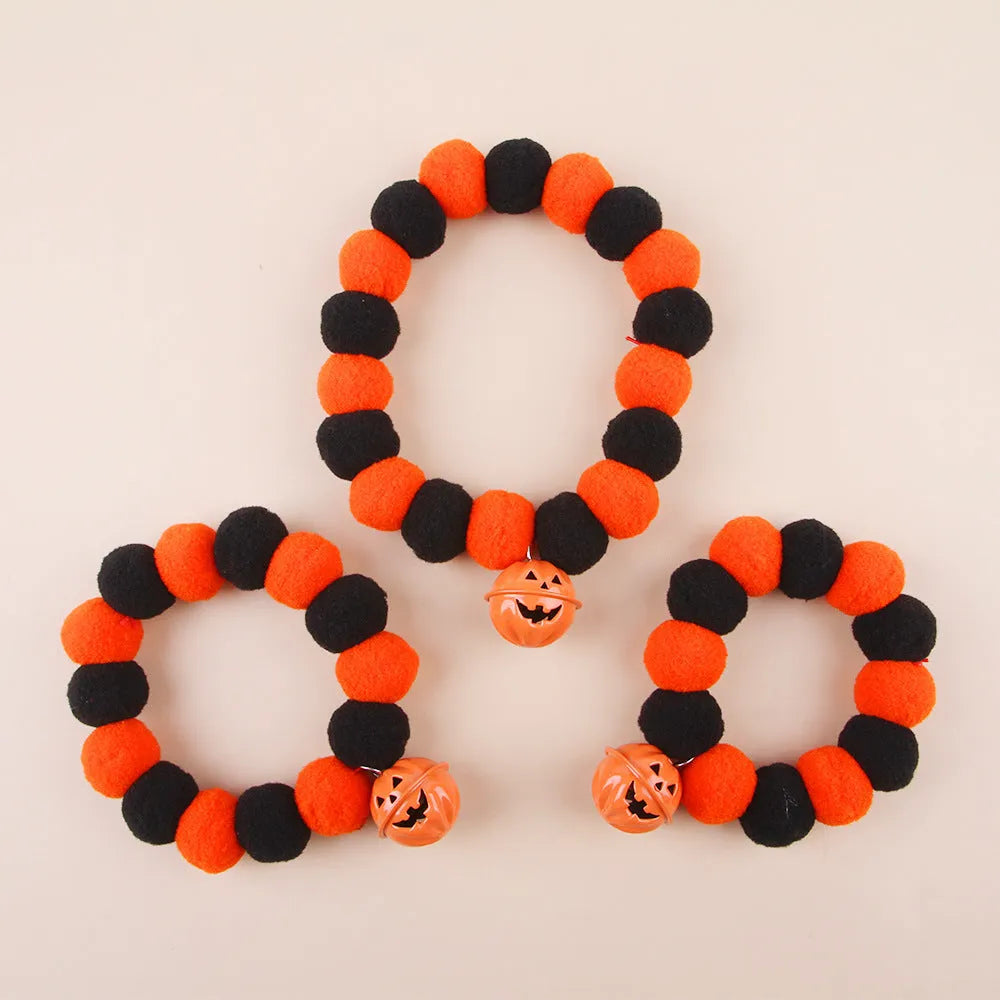 Orange Halloween pet collar with black trick-or-treat pumpkin design on a cat.