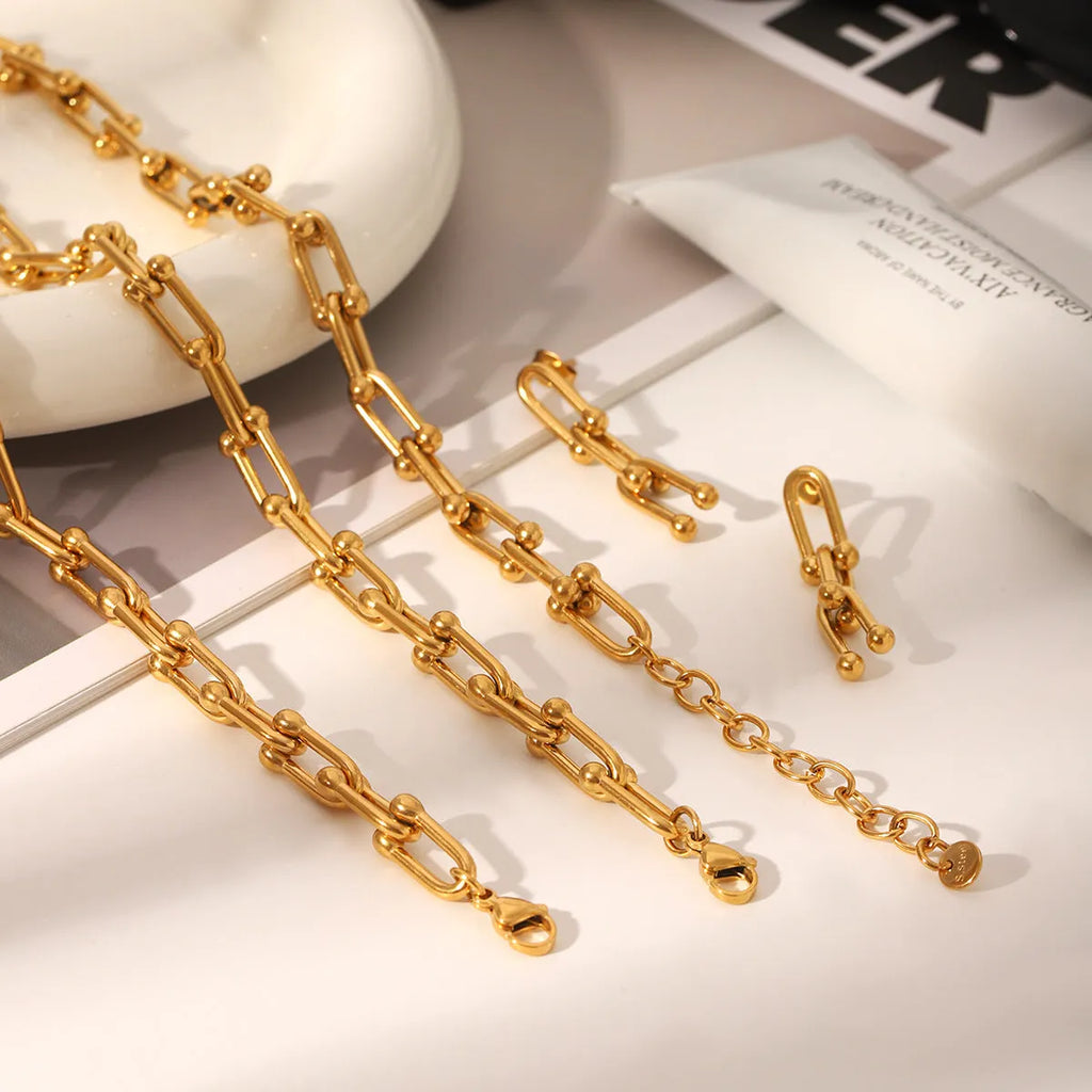 Stainless steel horseshoe chain jewellery set with titanium steel pendant showing necklace, bracelet and earring pieces