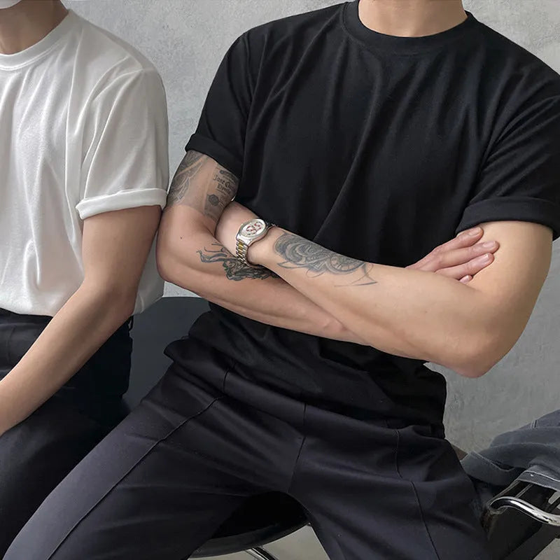 Men's slim fit cotton t-shirt in white or black with round neck and half sleeves on a model