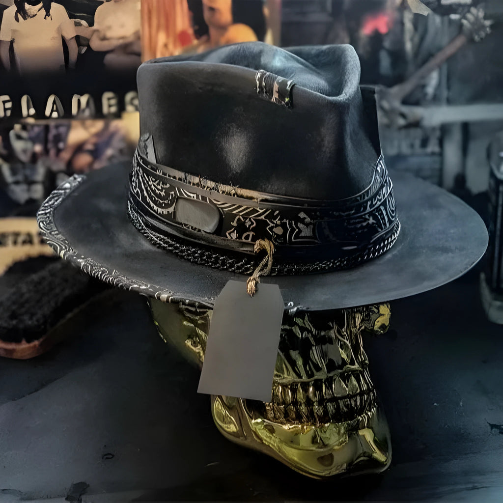 Handmade wool felt hat with conical crown and skull embroidery on a denim base.