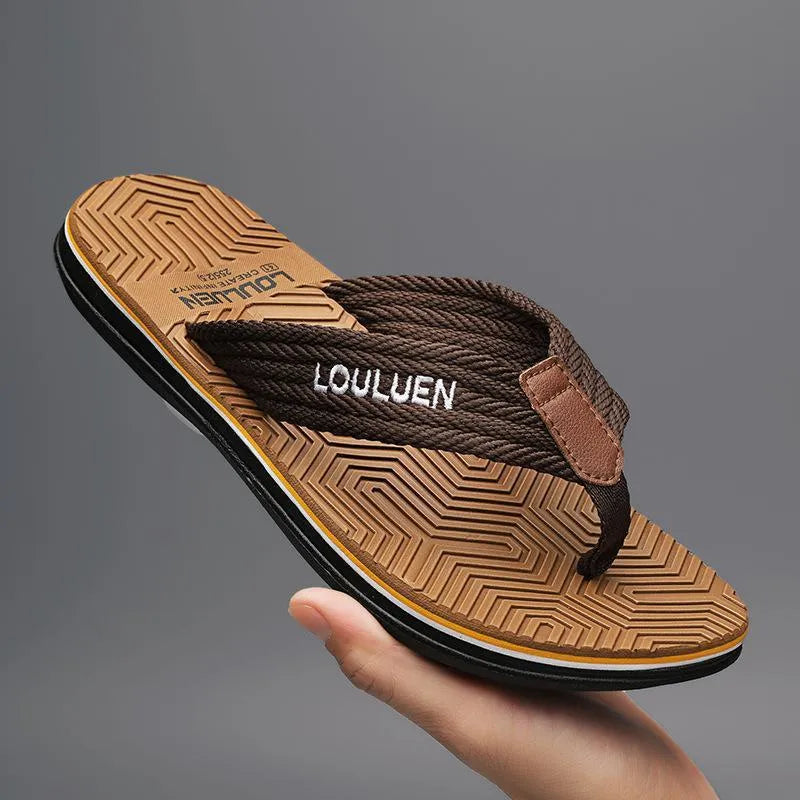 Men's black flip flops with textured non-slip PVC sole and EVA upper on a sandy beach.