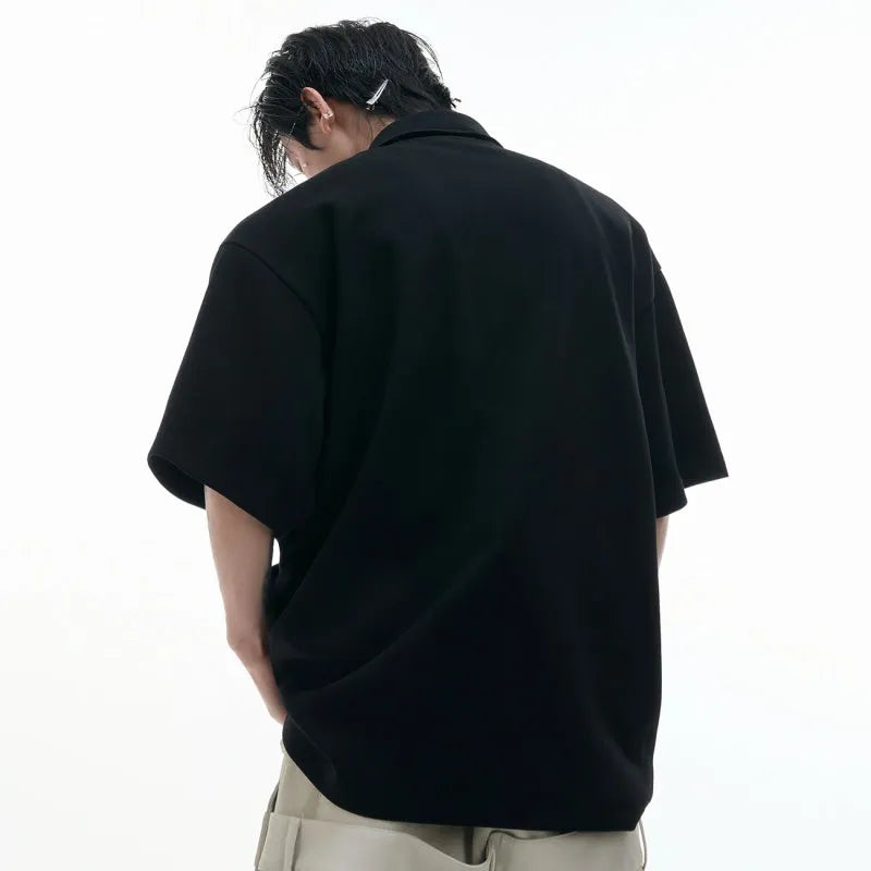 Men's loose-fit deconstructed polo shirt with a geometric pattern print on the chest.