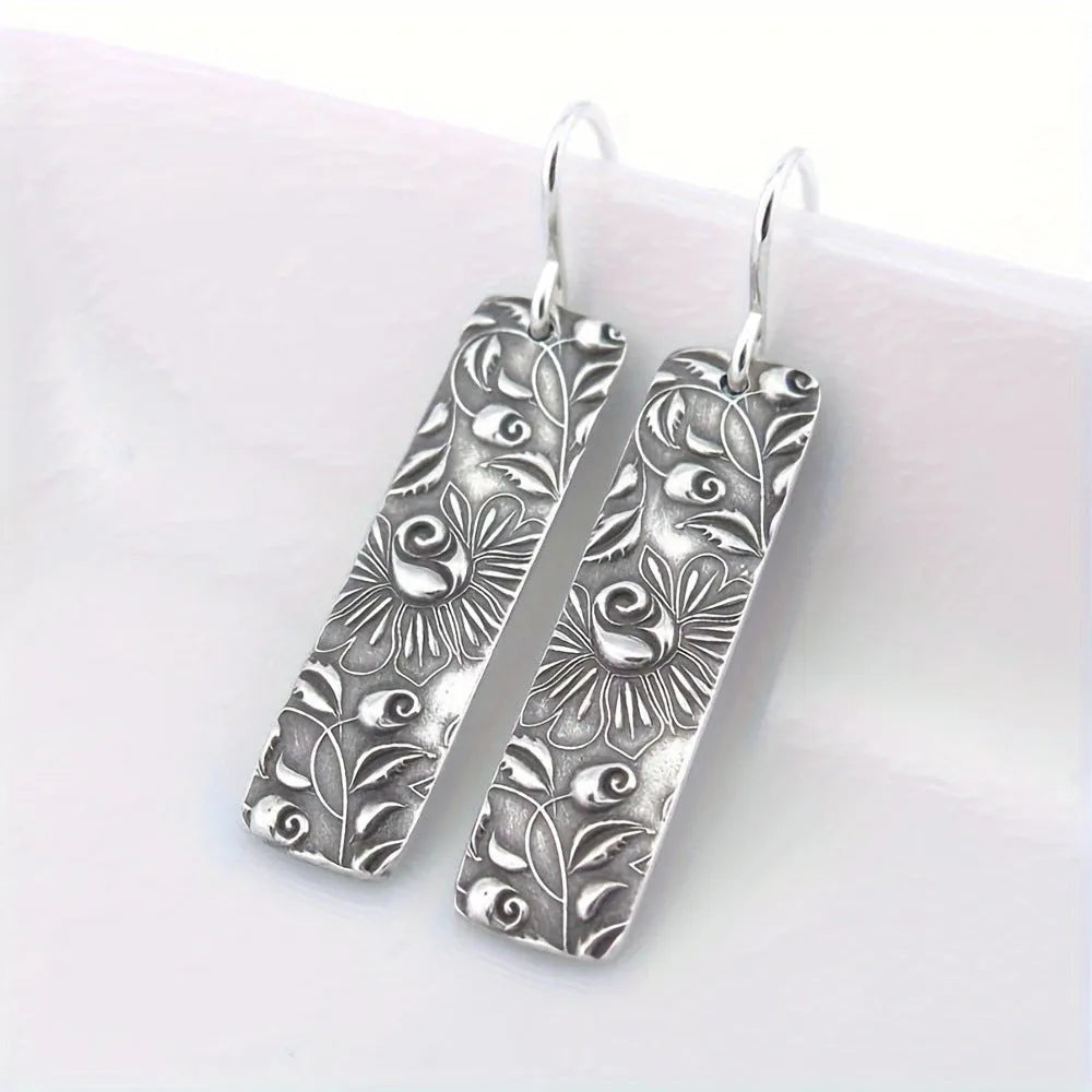 Silver geometric long drop earrings with carved vine patterns and retro design