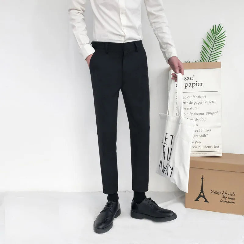 Men's slim straight-leg cotton trousers with a drawstring waist in black, shown front and side.