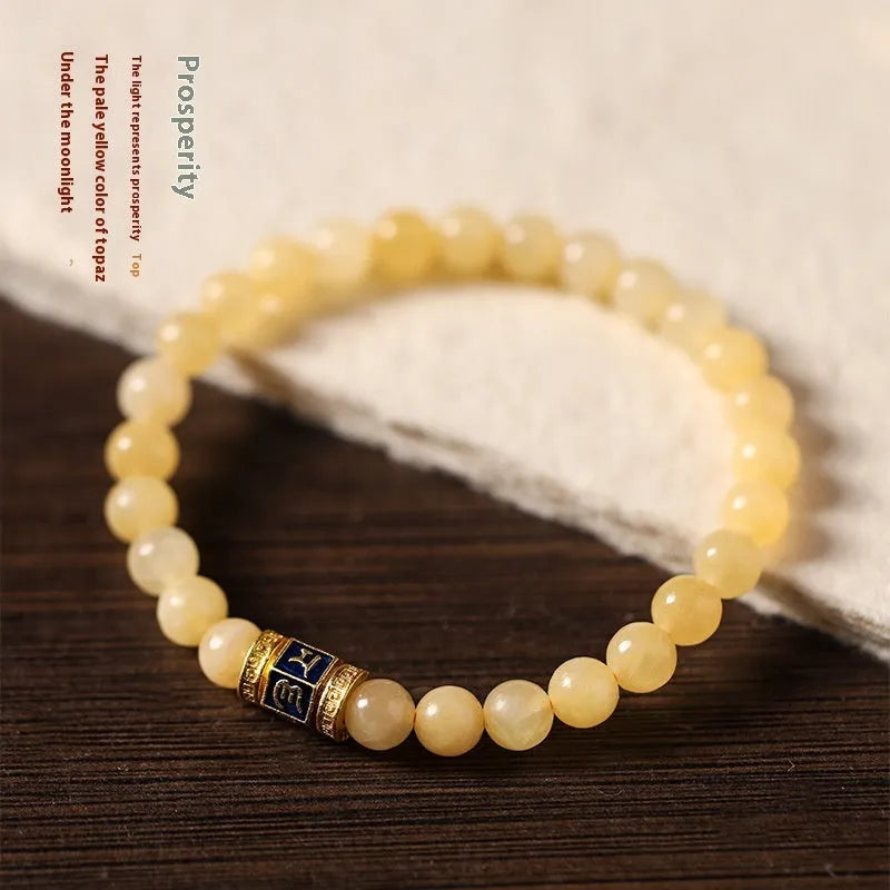 Topaz-coloured women's bracelet with six-word mantra barrel beads and sugar jade cubes in hand-woven design