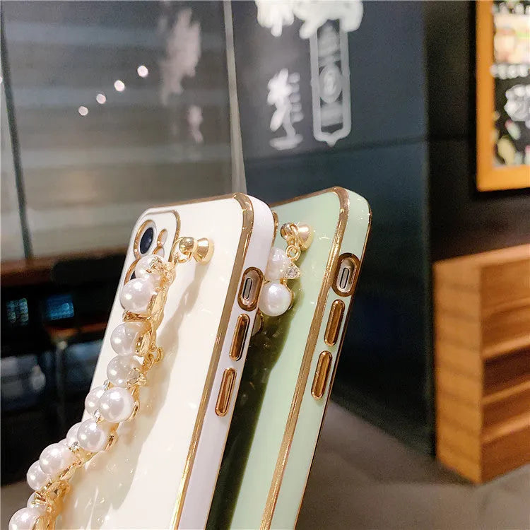 Soft TPU electroplated pearl wrist phone case for Apple iPhone in pink, showing back cover design.