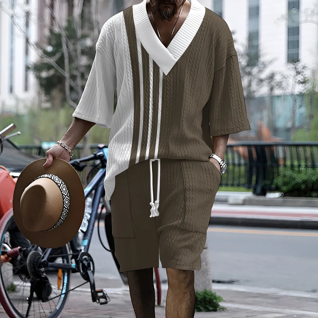 Man wearing a solid colour knitted short-sleeved top and matching shorts, showing the drop-shoulder design.