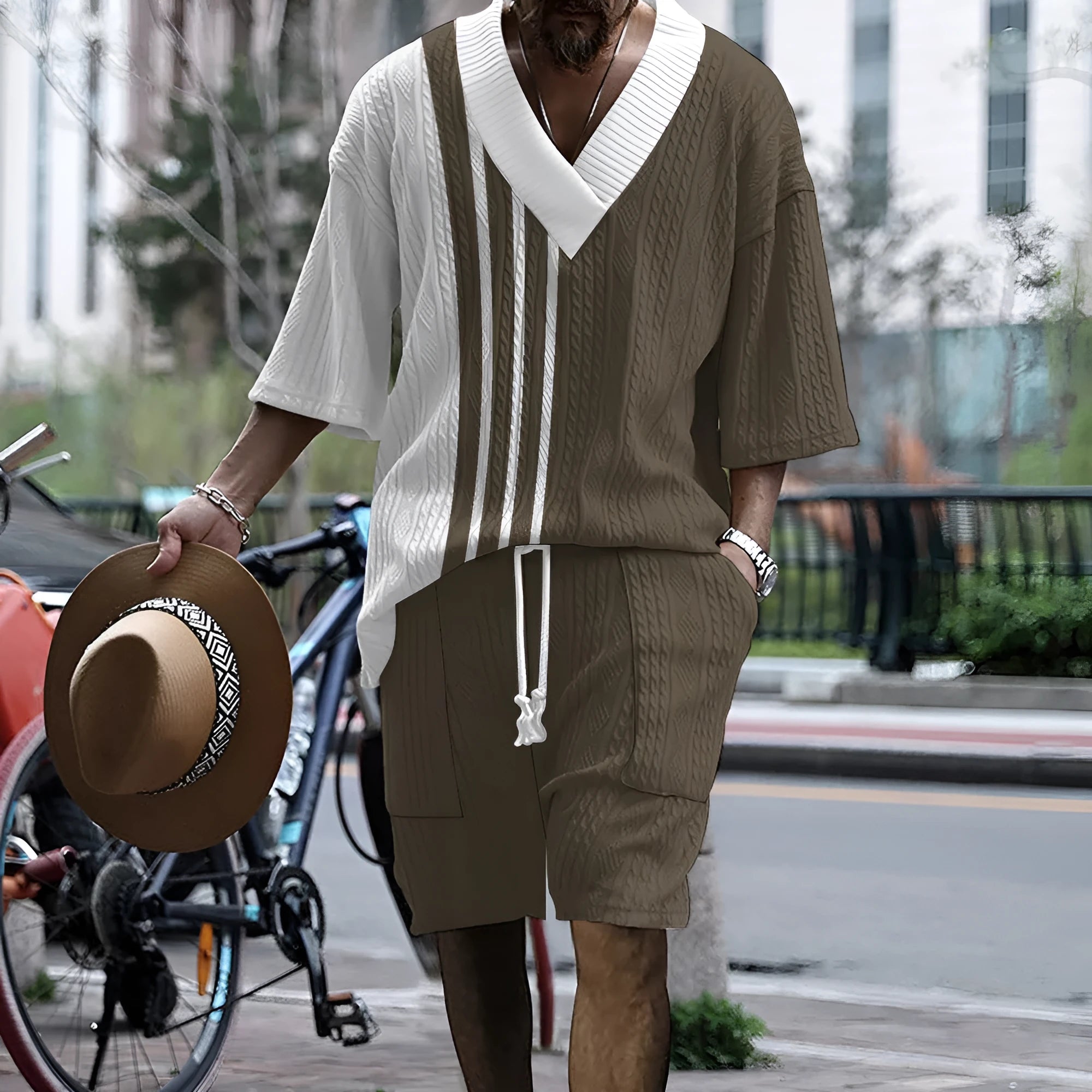 Man wearing a solid colour knitted short-sleeved top and matching shorts, showing the drop-shoulder design.