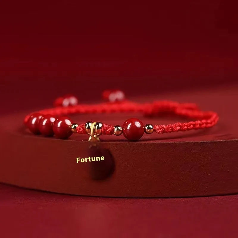 Cinnabar Ashore braided rope good luck bracelet with a blessing card charm.