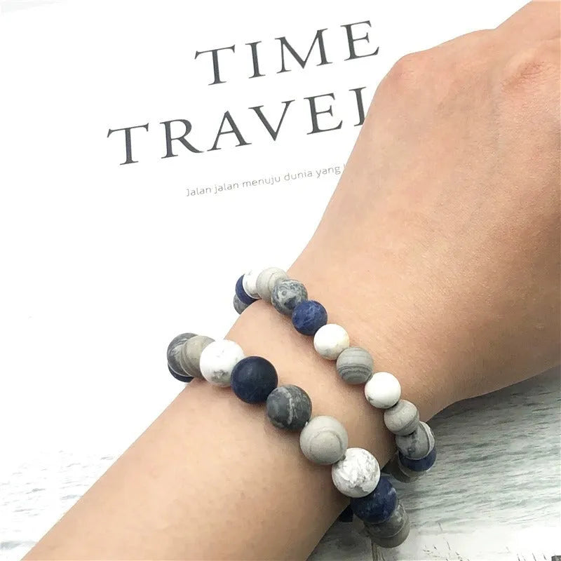 Handmade natural planet stone bracelet with starry design on a wrist, showing U-shaped profile.