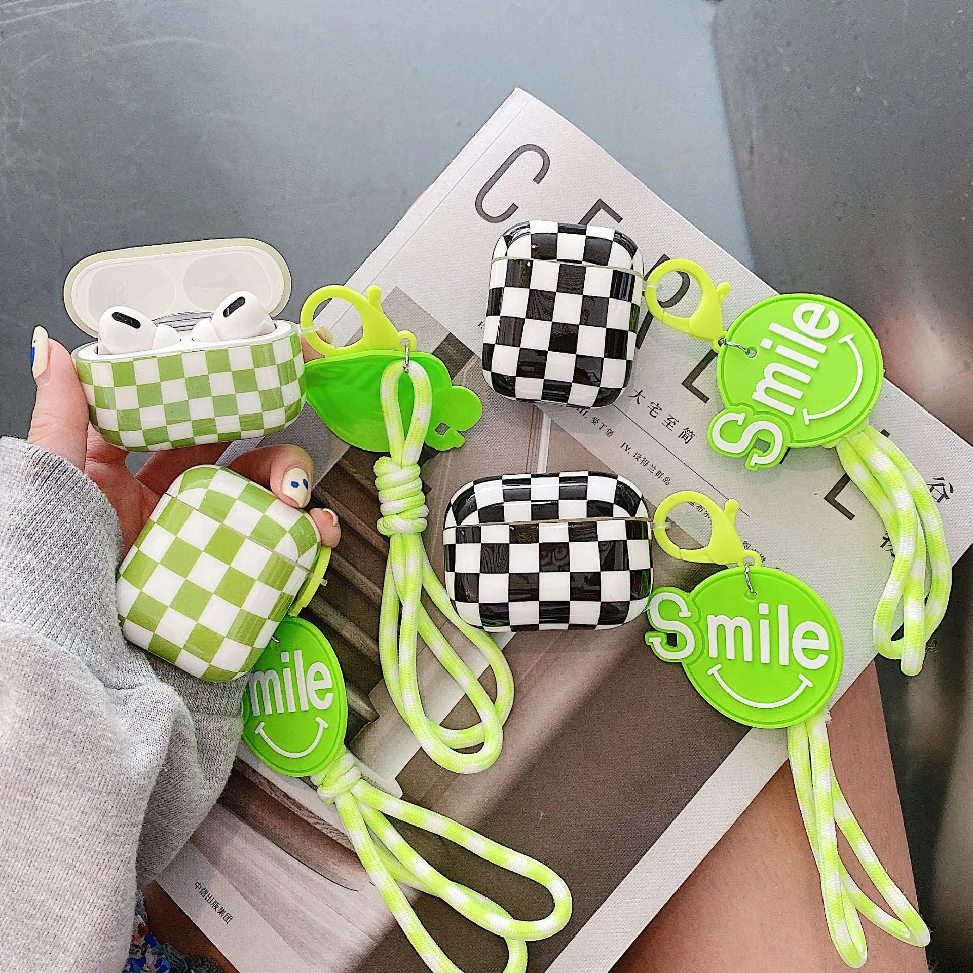 Black and green checkerboard lattice pattern TPU hard shell case covers for AirPods with optional lanyard and pendant attachments.
