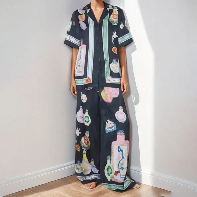 Black women's casual set with cartoon print, featuring a top with regular sleeves and matching trousers.