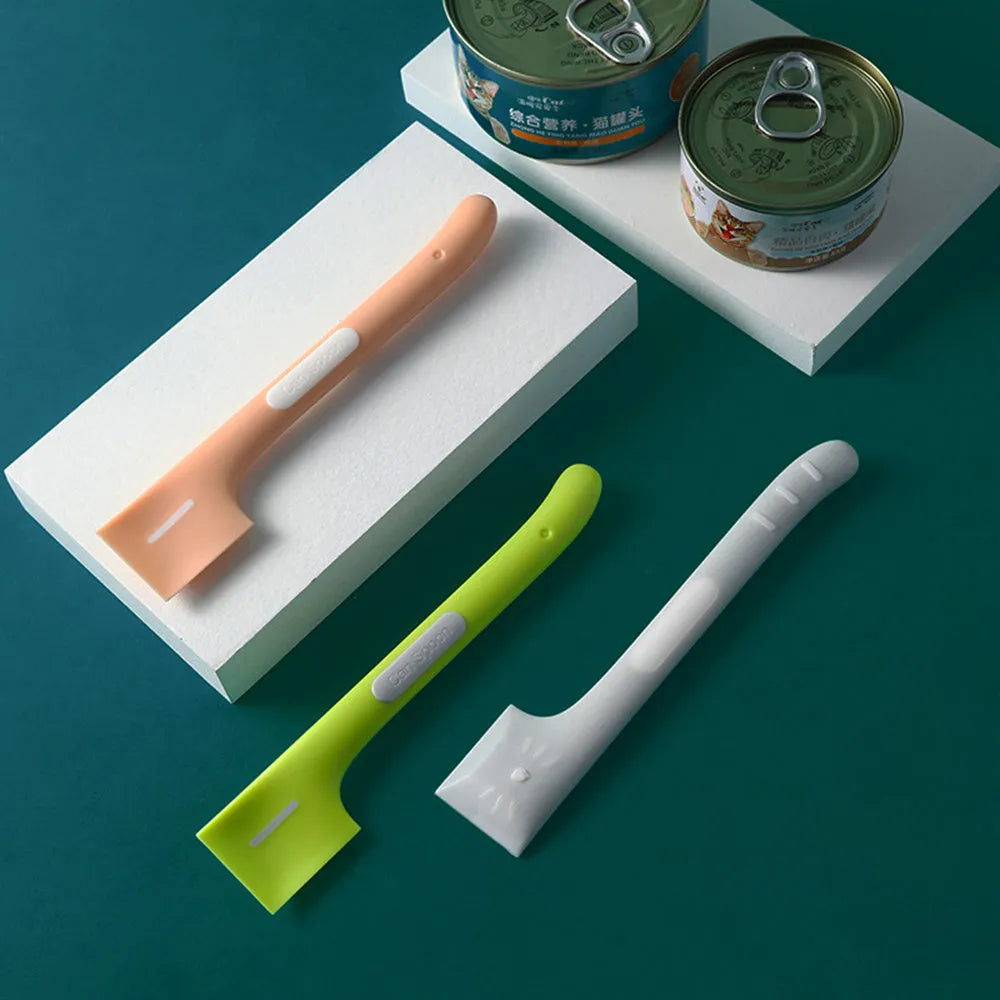 Green TPR pet feeding spoon with a long 16cm handle and right-angle scoop for canned wet food.
