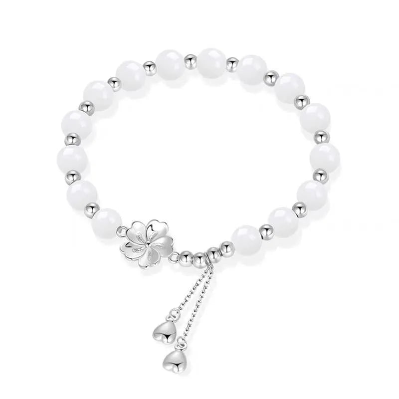 New Chinese style beaded bracelet with floral resin charms showing camellia, lotus and peach blossom designs