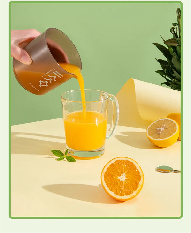 White green and pink coloured manual plastic citrus juicer for lemons and oranges on a kitchen counter.